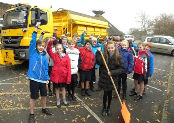 Olivia Bird, centre, celebrates winning the Name a Gritter competition