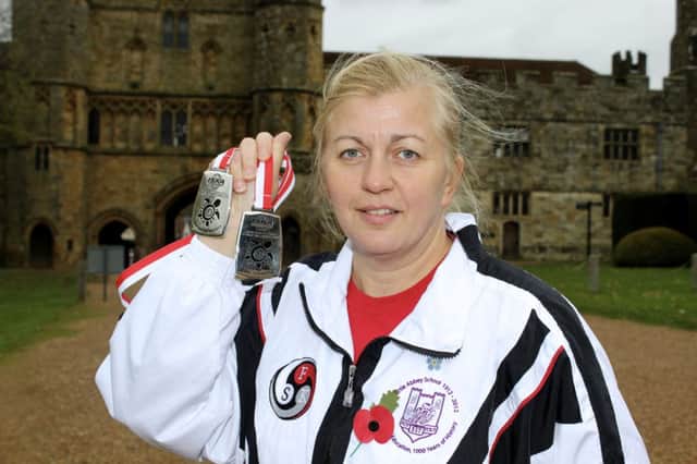 Zofia Malewicz outside Battle Abbey clutching her two silver medals from the World Kickboxing Championships