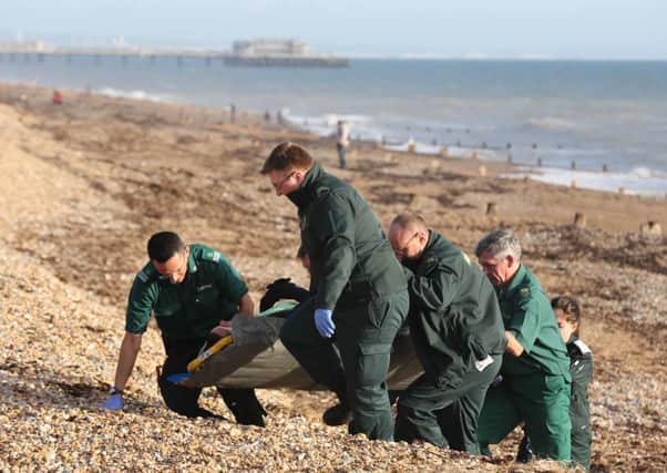 Ambulance crews carry the man up Worthing beach PICTURE: EDDIE MITCHELL