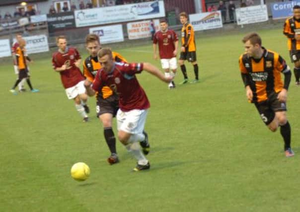 Hastings United wide midfielder Sam Adams takes on the Three Bridges defence. Picture by Simon Newstead