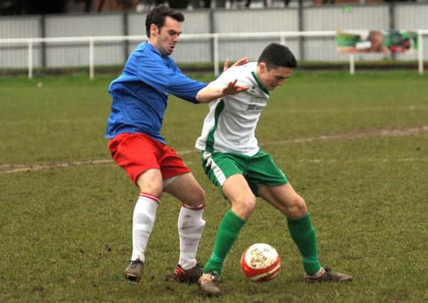 Morgan Forry tries to keep possession for Chichester against YMCA  Picture by Louise Adams C131710-2