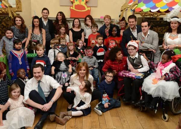 Thomas in back row next to Rupert Grint. He is wearing a red 'Rudolph' top with a 'tiger face'