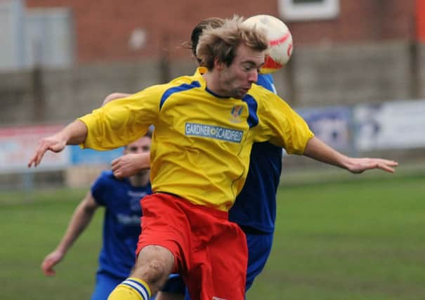 Lancing's Jonno Melia wins a header during Saturday's match