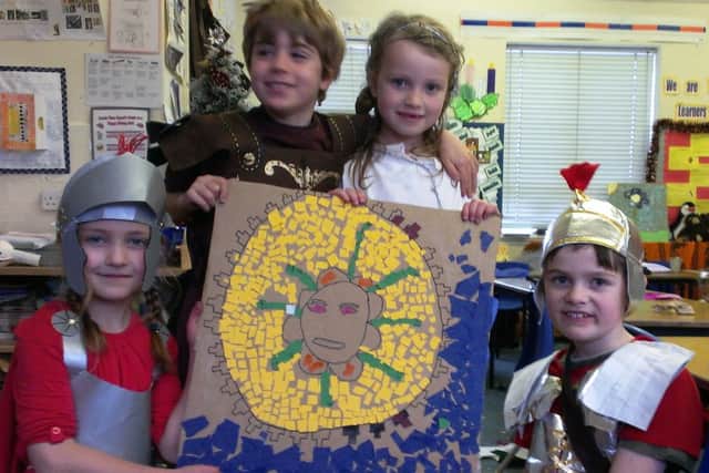 A mosaic of Medusa, being made by, from left, Cassie Arnold, seven, Gino Fiondella, seven, Mackenzie Muggeridge, eight, and Elisha Elton, seven