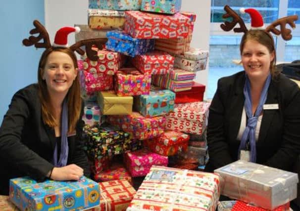 Regus staff with some of the shoeboxes collected by the workplace provider for the Operation Christmas Child Appeal