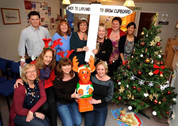 Nicky K-S (front row, 2nd from right) is delighted that Rudolph has been returned to the Brow Surgery in Burgess Hill