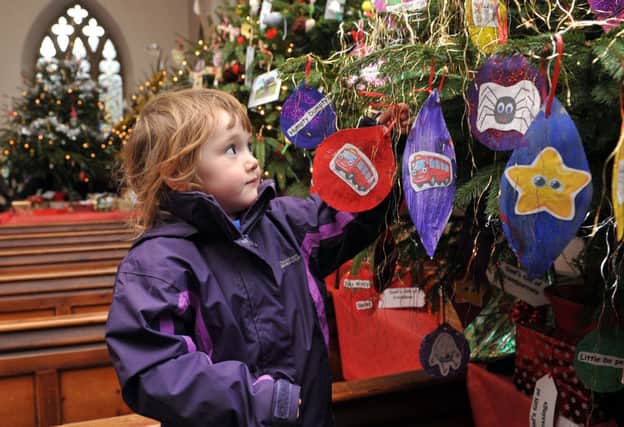W50101H13-StMary'sTrees

St Mary's Church Christmas Tree Festival. Pictured is Scarlet Pye (3) from Marriotts Nursary School.  Goring.
