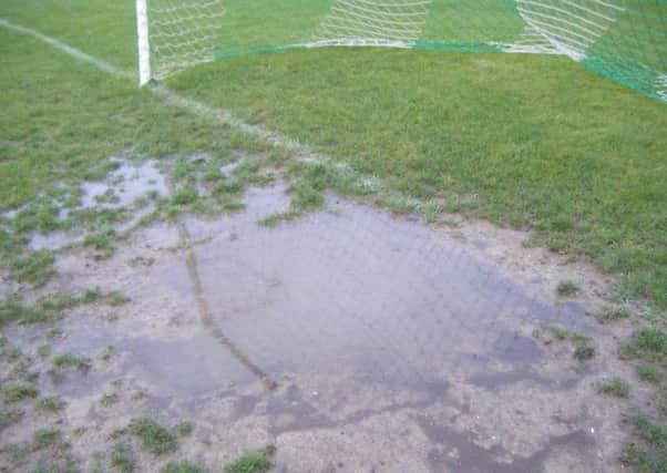Waterlogged pitch. Editorial image.