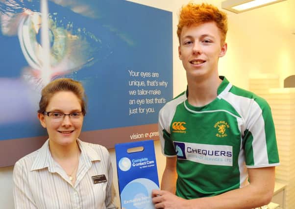JPCT 301213 Rugby player George Palmer 15, has been donated top of the range contacts by Vision Express so he can play to his best ability. Pictured with dispensing optician Katherine Rickards. Photo by Derek Martin