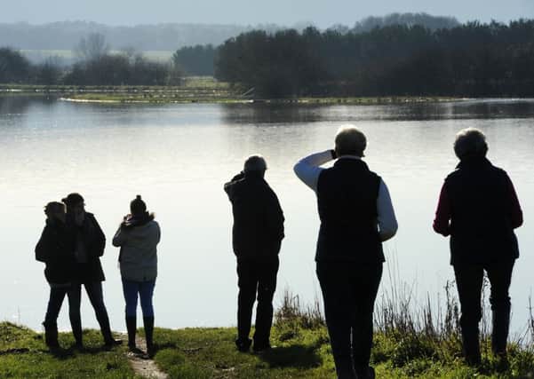 JPCT 261213 People view the flooded Pulborough Brooks. Boxing Day, 2013. Photo by Derek Martin