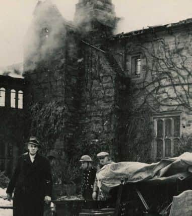 Wells the butler rescues furniture from the blazing house - Nymans, 19 Feb 1947