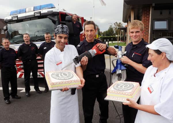 Fire crews in Littlehampton lend a hand to members of the Fire Fighters Charity during the organisation's 70th anniversary, last year               L34534H13