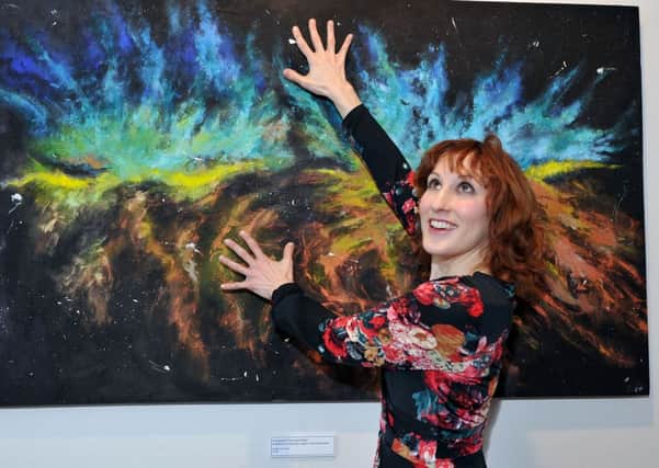 Pictured is Cat Mclelland with her painting," A Hundred Thousand Stars", from her, "Journeys, Memories, Dreams, Reflections",  exhibition. Littlehampton.