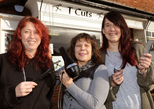 JPCT 130114  Tracy Bassett, left, owner of T Cuts hair salon, Horsham is donating a day's takings to charities once a month this year. Pictured with stylists Dom Berwick (middle) and Marisa Campbell. Photo by Derek Martin