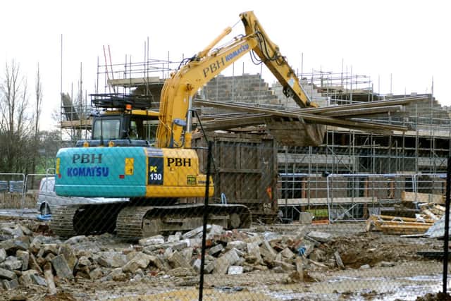 Some of the newly built homes at Chalker's Vale are being demolished. Pictured here, some of the floor beams are moved across the site. Pic Steve Robards