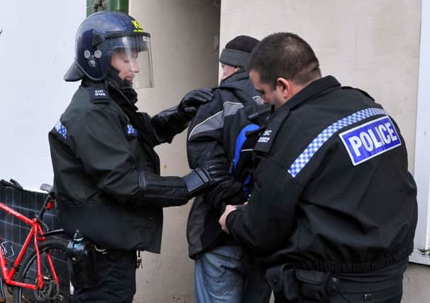 Police detain a man outside a flat in Norfolk Road      L03124H14