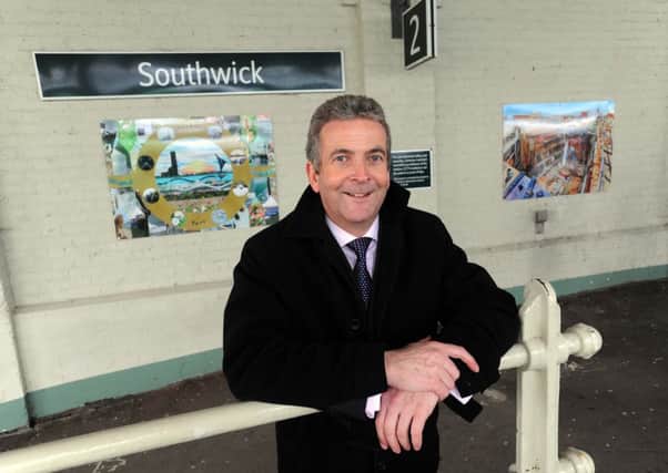 Shoreham Port chief executive Rodney Lunn at Southwick railway station with last year's art winners S03515H13