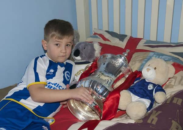 Seven-year-old Will Strachan with the FA Cup