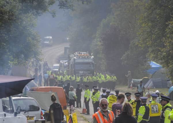 Cuadrillas in the mist. Cuadrilla fracking rig is driven away from the Balcombe site escorted by part of the massive Police presence at Balcombe.Exclusive picture by photographer David Burr.