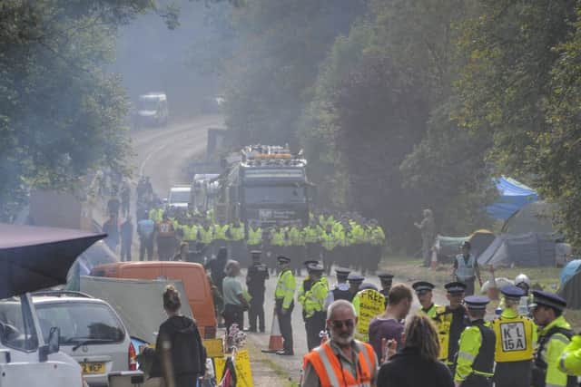 Cuadrillas in the mist. Cuadrilla fracking rig is driven away from the Balcombe site escorted by part of the massive Police presence at Balcombe.Exclusive picture by photographer David Burr.