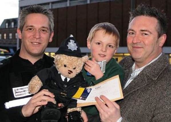 Sergeant Dave Palmer with Oliver, five, and his father, Jean-Marc Poinsignon