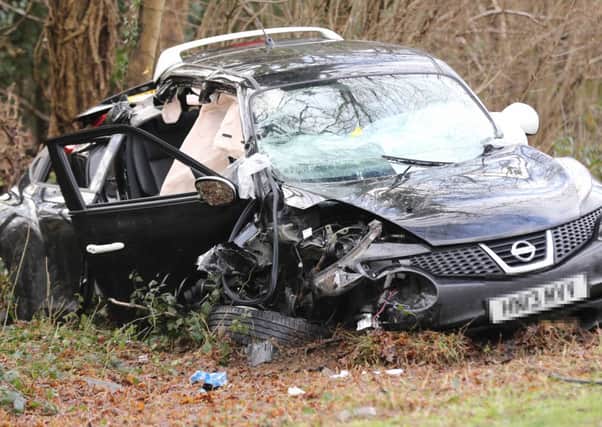 A woman was rushed to hospital after being taken out of this car. PHOTO: Eddie Mitchell