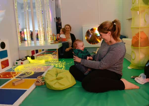 W04376H14 Vicky Feeney, with her one-year-old son Henry, in the sensory room