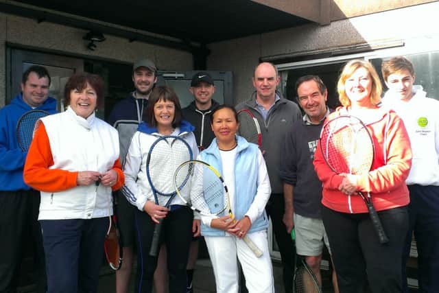 Members of the Horley Lawn Tennis Club outside their clubhouse, which they hope to demolish and rebuild
