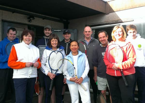 Members of the Horley Lawn Tennis Club outside their clubhouse, which they hope to demolish and rebuild