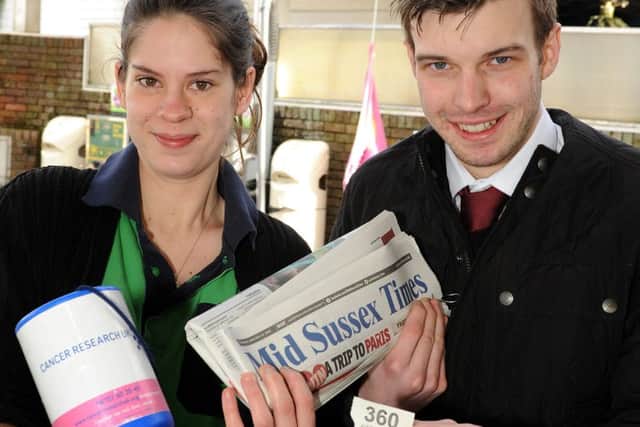 Clare Radford of Scaynes Hill Service Station hands a raffle ticket to reporter James Oxenham. The service station will be raising money all day on Feb 13th for Cancer Research. Pic Steve Robards