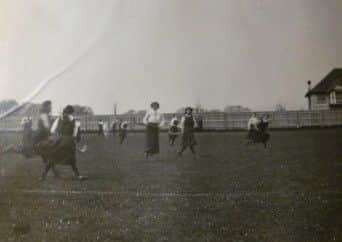 Girls playing hockey at the school in 1913