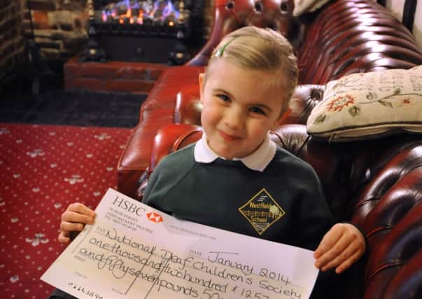 Elizabeth Kite, age 6, with a cheque for £1257.50 raised by the Mermaid Hotel, Rye, over the Christmas period in aid of National Deaf Children's Society.
