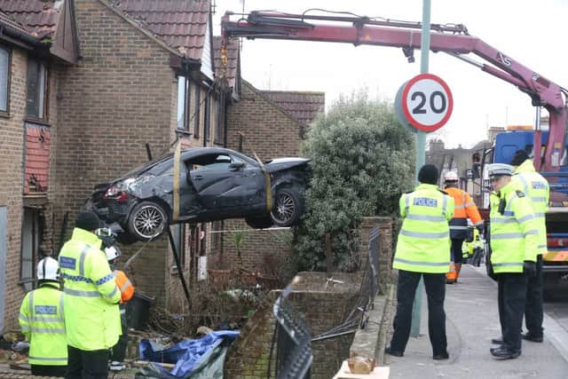 The car, which is believed to have been stolen from Angmering, is removed from the house. PHOTOS: Eddie Mitchell