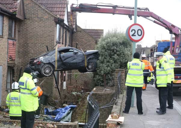 The car, which is believed to have been stolen from Angmering, is removed from the house. PHOTOS: Eddie Mitchell