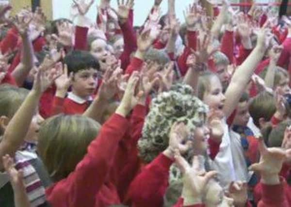 300 staff and pupils at Holy Trinity Primary School in Cuckfield perform Get Up & Sign