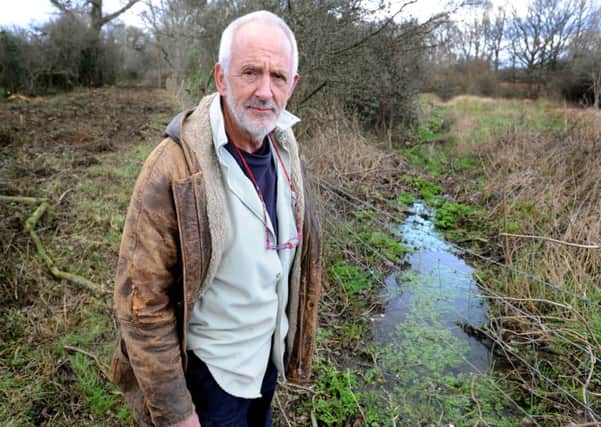 A stream on Ditchling common that doesn't belong to the residents is now barely flowing because the vegetation has been allowed to grow and should be cleared. Resident Brian Denyer-Baker isn't happy with the situation. Pic Steve Robards
