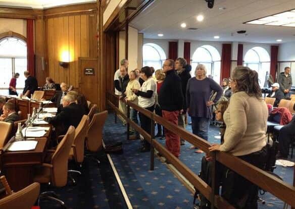 Margaret Guest (white tshirt and black sleeves) halts the meeting at County Hall