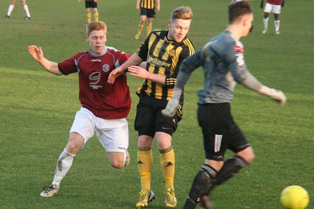 Hastings United striker Trevor McCreadie closes down Merstham's goalkeeper Brannon Daly on Saturday. Picture by Terry S. Blackman