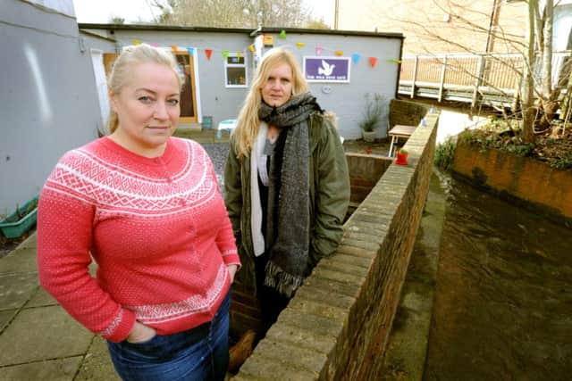 Business owners Sam Holland and Jane Nayar and at Wild Dove Cafe, next to Spitalford Bridge, Hassocks, where it looked like the cafe was in danger as the water level exceeded the height of the wall on the right of the picture. Pic Steve Robards