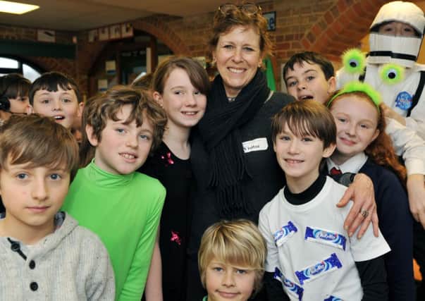 Pictured is Marcia with year five pupils
