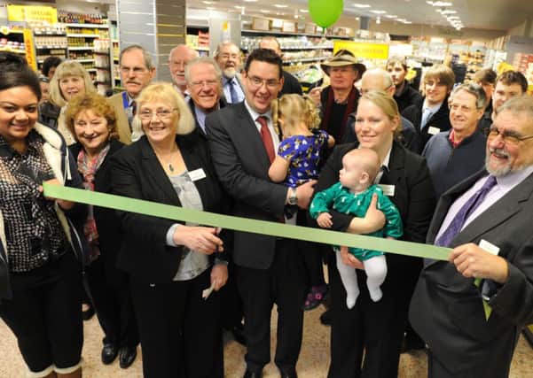 JPCT 130214 S14080043x Henfield. Budgens refit. Marie Knight cuts ribbon, owner David Knight with daughter Isabelle,3, wife Lynette Knight with daughter Charlotte -photo by Steve Cobb