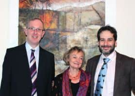 From left to right: Jeremy Knight, Alison Milner-Gulland and Nick Toovey standing in front of the painting Deep in the Downs.
