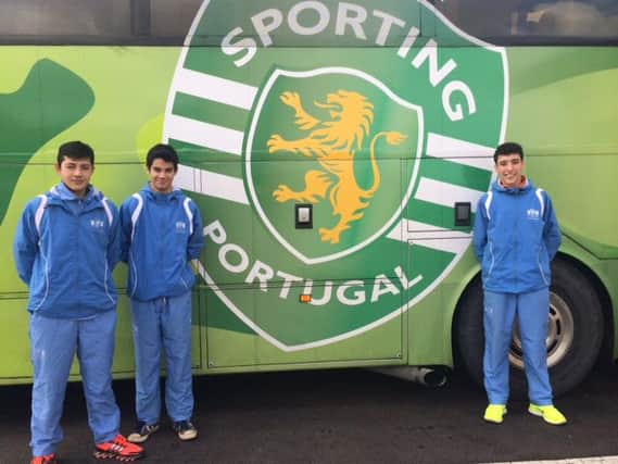 Three Buckswood Football Academy students outside the Sporting Lisbon club coach