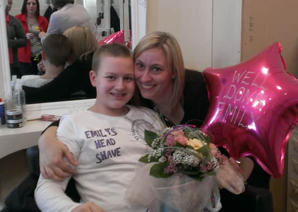 Emily Dyer, 12, with her mum Angela Frazer after her headshave for St Catherine's Hospice