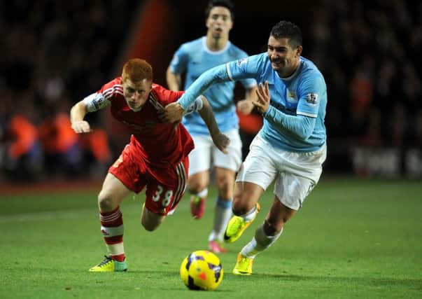 Southampton's Harrison Reed battles for the ball with Manchester City's Aleksandar Kolarov