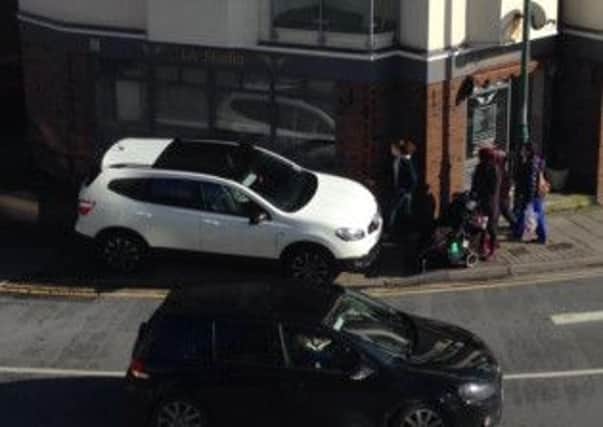 Cars parked on the pavement have forced pedestrians into the road (picture supplied)