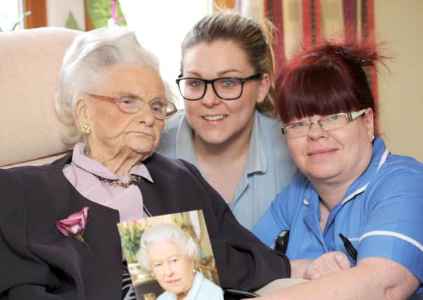 JPCT 240214 105 year old  Edith Arnold celebrating her birthday with staff at Hillside Lodge, Pulborough, Hannah Peppard left and Mary Wilson. Photo by Derek Martin