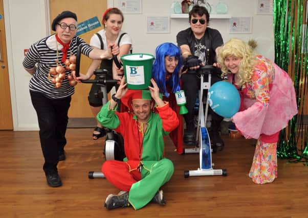 Organisers Gemma Fielder and James MacEwan on the bikes, with owner Zoe Bates, centre, and other staff at the care home S09090H14