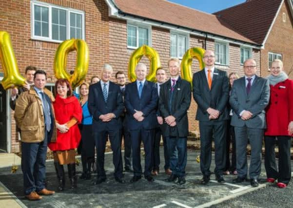 Horsham District councillor for Southwater Claire Vickers with Saxon Weald chairman, David Avery, chief executive, David Standfast, and members of the company's development team outside the 1,000th home at Roman Lane, Southwater - photo by Toby Phillips