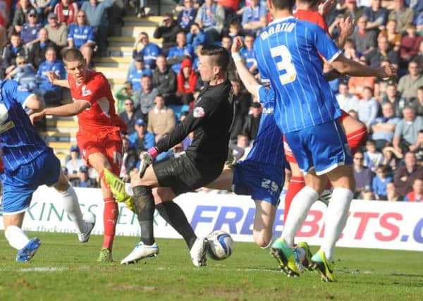 Jamie Proctor shoots during the first half against Gillingham (Pic by Jonn Rigby)